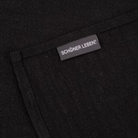 Detailansicht des schwarzen Geschirrtuchs mit SCHÖNER LEBEN. Label – hochwertige Kantenverarbeitung