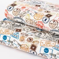 Baumwolljerseystoff Stamps Stempel Reisepass wollweiß braun blau 1.45m