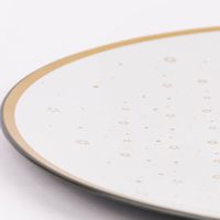 Detailaufnahme Tellerrand vom Platzteller mit goldfarbigem Sternmuster