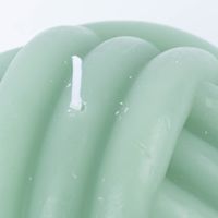 Detailaufnahme docht dunkelgrüne kerze in knotenform