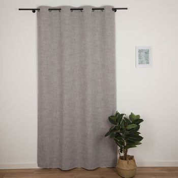 Grauer Ösenvorhang komplett zugezogen vor einer weißen Wand, daneben eine Pflanze im Korb.