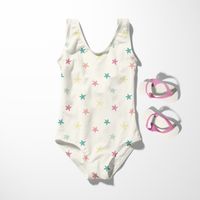 Kinderbadeanzug aus Badeanzugstoff mit bunten Seesternen auf wollweißem Grund