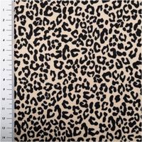 Jerseystoff aus Baumwolle mit klassischem Leopardenmuster in Schwarz auf beigefarbenem Hintergrund, dehnbar und angenehm für Bekleidung geeignet - mit Massband