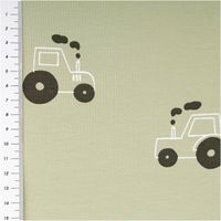 Baumwolljersey in hellem Grün mit kindlichem Traktor-Muster in Schwarz und Weiß, weich wirkend, elastisch und ideal für Kinderkleidung geeignet - mit Massband