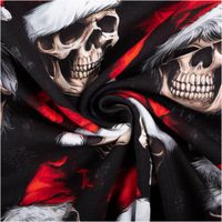 French Terry Stoff in Schwarz mit auffälligem Weihnachtsmotiv: cremefarbene Totenköpfe mit roten Nikolausmützen und weißen Fellkanten, markant und außergewöhnlich - kunstvoll eingedreht in Falten