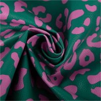 Grün-pinkes Kunstleder „Happy Leo“, präsentiert mit modernem Leopardenmuster von Cherry Picking by Swafing für kreative Nähprojekte - kunstvoll eingedreht in Falten