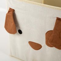 Praktische Aufbewahrungsbox in faltbarem Design mit einem niedlichen Hunde-Gesicht und applizierten Schlappohren in Braun. Die hellbeige Box von Atmosphera bietet mit 29 x 29 x 29 cm idealen Stauraum für das Kinderzimmer - Detailaufnahme