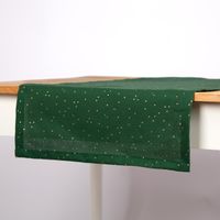 Grüner Tischläufer 40x160 cm aus Baumwoll-Canvas mit Goldpunkten auf hellem Esstisch.