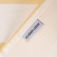 Rückseite des Baumwoll-Tischläufers Vanille Ecru mit SCHÖNER LEBEN Etikett und sauber verarbeitetem Rand