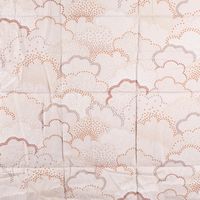 Beige und orange gepunktetes Muster auf Stoff
