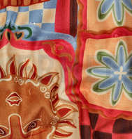 94946-Tischdeckenstoff-abwaschbar-Patchwork-bunt-wasserabweisend-1-48m-Breite-Screenshot-2026-05-22-180833.png Detailaufnahme des wasserabweisenden Patchwork-Stoffs mit buntem Design und abperlenden Wassertropfen
