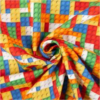 Baumwoll-Webware „Bill" von Swafing, 1,47 m breit, mit dichtem Baustein-Muster in Rot, Blau, Gelb, Orange, Grün und Weiß – farbenfroh, verspielt und perfekt für Kindermode oder Accessoires - kunstvoll eingedreht in Falten