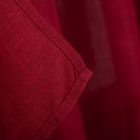 Detailaufnahme des roten Stoffs mit sichtbarer Webstruktur und Saumkante.