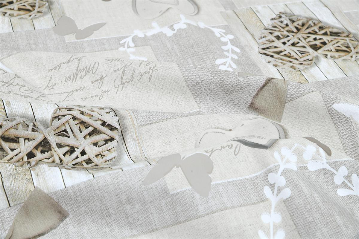 Abwaschbarer Tischdeckenstoff mit Rattanherzen und Schleifen auf Holzoptik in Grau und Beige, Makroaufnahme der Oberfläche.