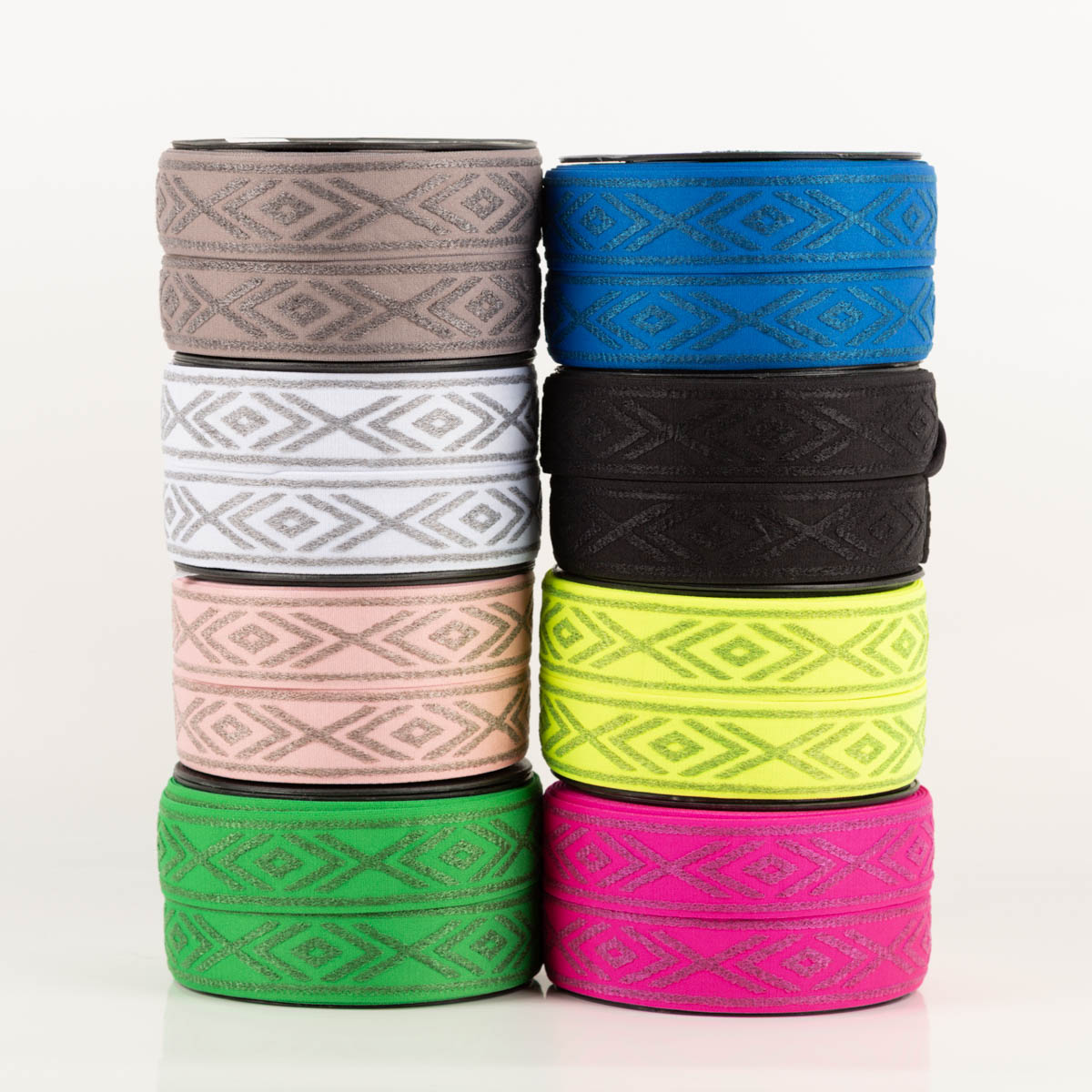Gummiband Glitzer Rauten geometrisch weiß silber 4cm Breite acht verschiedenfarbige Rollen Gummiband mit geometrischem Rautenmuster übereinandergestapelt
