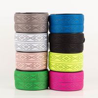 Gummiband Glitzer Rauten geometrisch weiß silber 4cm Breite acht verschiedenfarbige Rollen Gummiband mit geometrischem Rautenmuster übereinandergestapelt