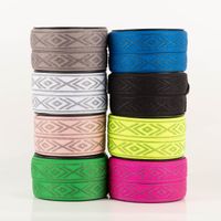 Gummiband Glitzer Rauten geometrisch schwarz silber 4cm Breite Acht Rollen elastisches Band mit Rautenmuster in verschiedenen Farben übereinander gestapelt
