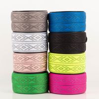 Gummiband Glitzer Rauten geometrisch neongelb silber 4cm Breite acht verschiedenfarbige Rollen eines elastischen Bands mit geometrischem Silbermuster, gestapelt nebeneinander