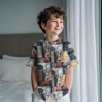 Junge in einem kurzärmeligen Hemd aus Popeline mit Weltraum-Patchwork am Fenster