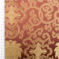 Jacquardstoff mit goldfarbenen Ornamenten auf dunkelbraun, Stoff flach ausgebreitet mit Maßband links sichtbar