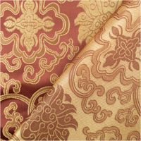 Jacquardstoff mit dunklem Grund und goldfarbenen Brokat-Ornamenten, Stoffkante aufgeschlagen für Material- und Musteransicht