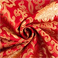 Jacquardstoff Brokat Ornamente rot gold 1,50m Breite Brokatstoff in Rot mit goldfarbenen Ornamenten, dekorativ zur Spirale gedreht, textile Struktur im Fokus