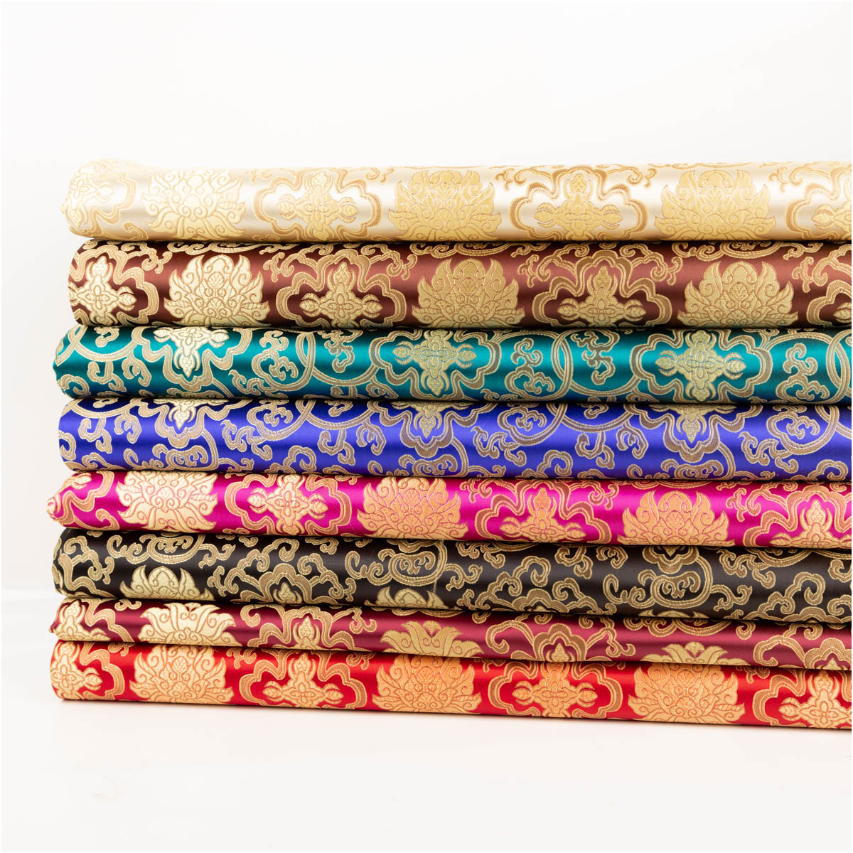 Jacquardstoff Brokat Ornamente petrol gold 1,50m Breite Stoffstapel aus Jacquard mit goldenen Ornamenten in mehreren Farben, von creme bis petrol und pink