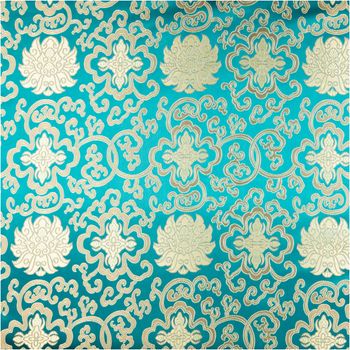 Jacquardstoff Brokat Ornamente petrol gold 1,50m Breite Nahaufnahme von Brokatstoff mit goldenen Ornamenten auf petrolfarbenem Hintergrund
