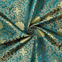 Brokat Jacquardstoff petrol gold drapiert – edler Glanz des eingewebten Musters Brokat Jacquardstoff petrol gold drapiert – edler Glanz des eingewebten Musters