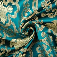 Jacquardstoff Brokat Ornamente petrol gold 1,50m Breite Jacquardstoff in Petrol mit goldfarbenen Ornamenten, dekorativ zur Spirale gelegt