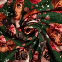 grüner Sweatstoff mit Dackelköpfen im Weihnachtslook, rosa Schleifen und Schneeflocken, zur Spirale gedreht