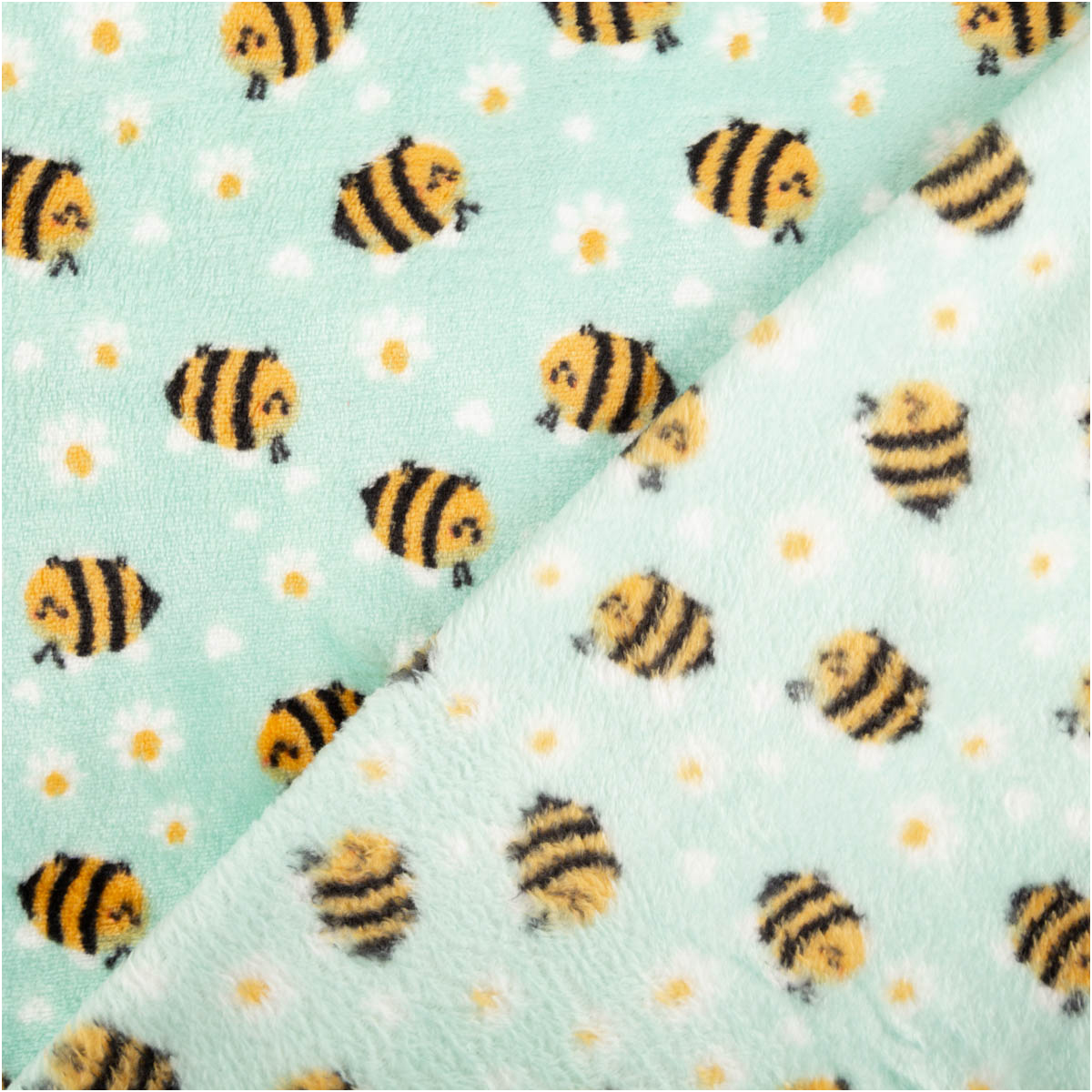 zwei Lagen mintfarbener Polarfleece mit Bienen und weißen Blumen, Vorder- und Rückseite sichtbar, weiche Struktur