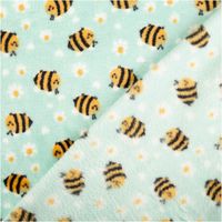 zwei Lagen mintfarbener Polarfleece mit Bienen und weißen Blumen, Vorder- und Rückseite sichtbar, weiche Struktur