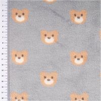 Fleece Stoff in Grau mit braunen Teddybär-Gesichtern, Nahaufnahme, links Maßband sichtbar