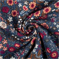 Feincordstoff in Petrolfarben zur Spirale gelegt, Blumenmuster in Rosa, Orange und Weiß deutlich sichtbar