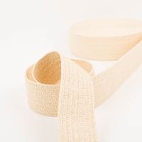 Gurtband elastisch Jute-Optik ecru 6cm zur Schlaufe gelegt vor der Rolle, elastisches Band